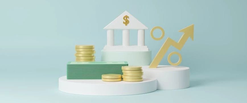 a pile of U.S. dollar notes, three piles of gold coins, a white building with the dollar sign, and a percentage sign with an arrow on the light blue background.