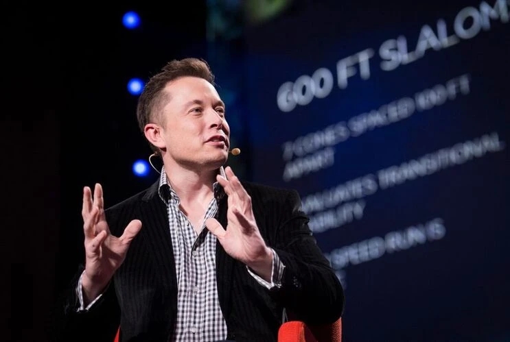 Elon Musk speaking at a conference