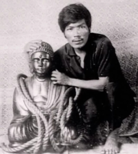 rogelio roxas the treasure hunter posing next to the golden buddha statue filled with diamonds that was part of the Yamashita treasure made of piles of gold bars and jewels looted during world war II