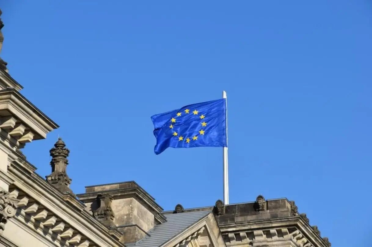 European flag flying with a blue sky behind