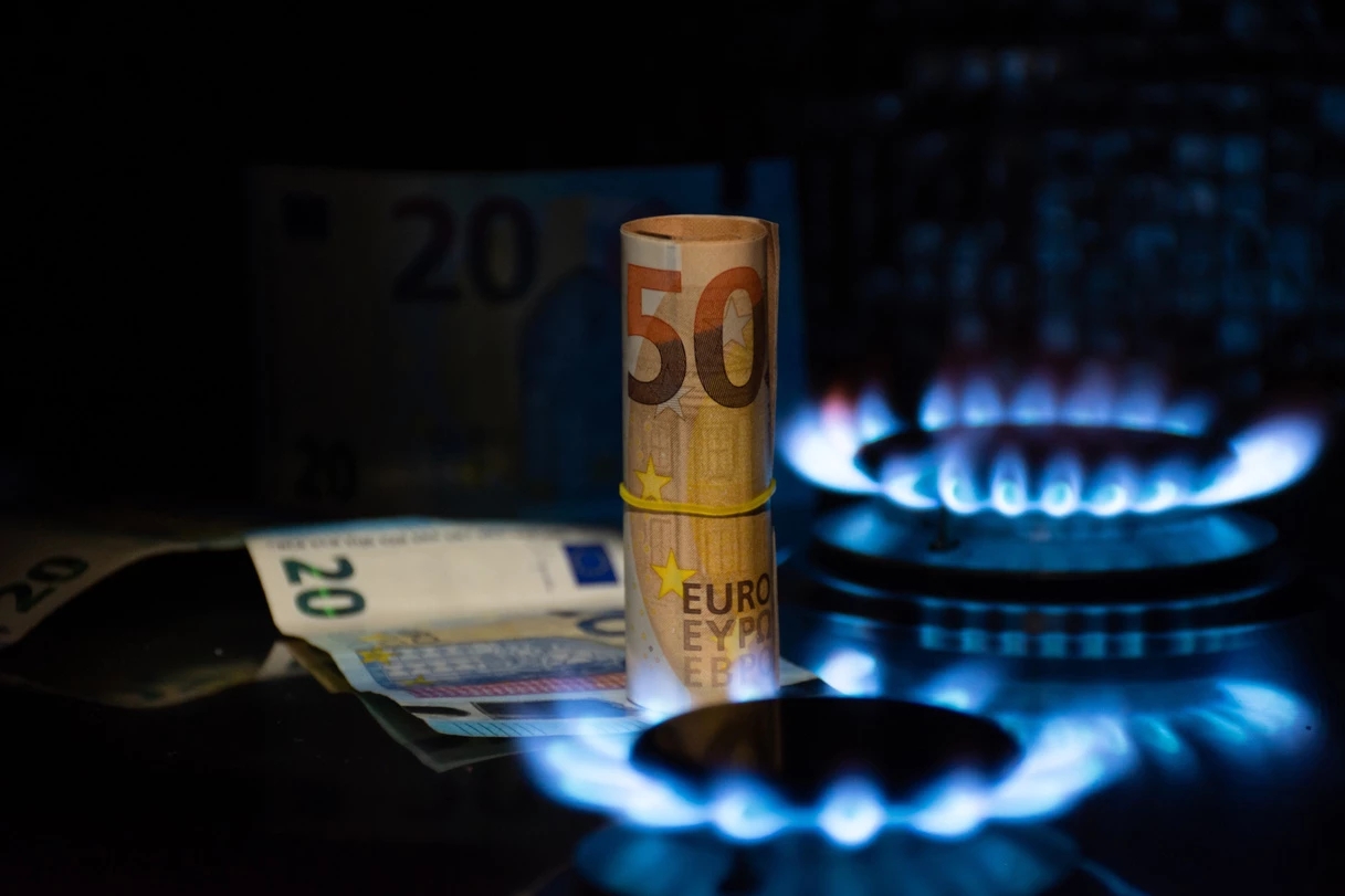 Euro banknotes and a working gas stove