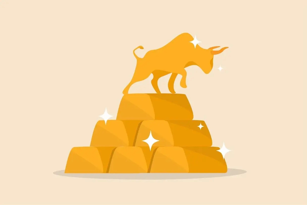 An illustrated golden bull representing a bullish gold market is standing on a pile of shiny gold bars