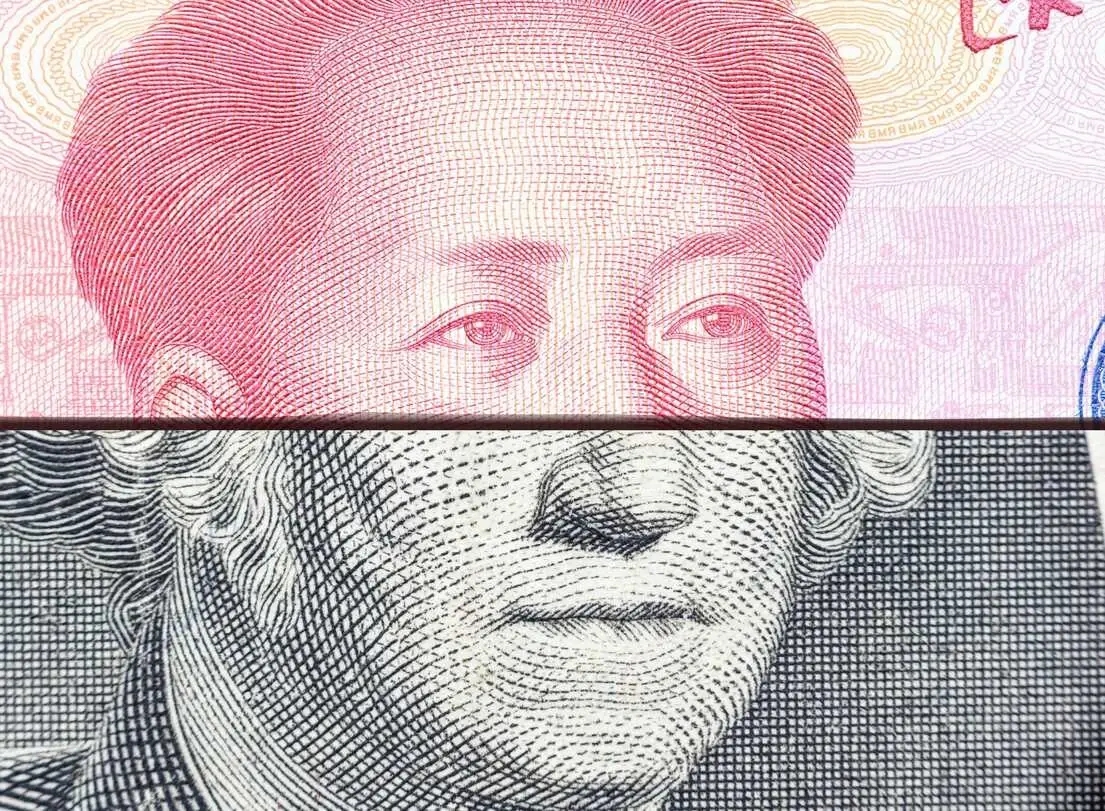 a U.S. Dollar and Chinese yuan bills folded on top of each other to combine the face of the Chinese and American historical figures present on the currency