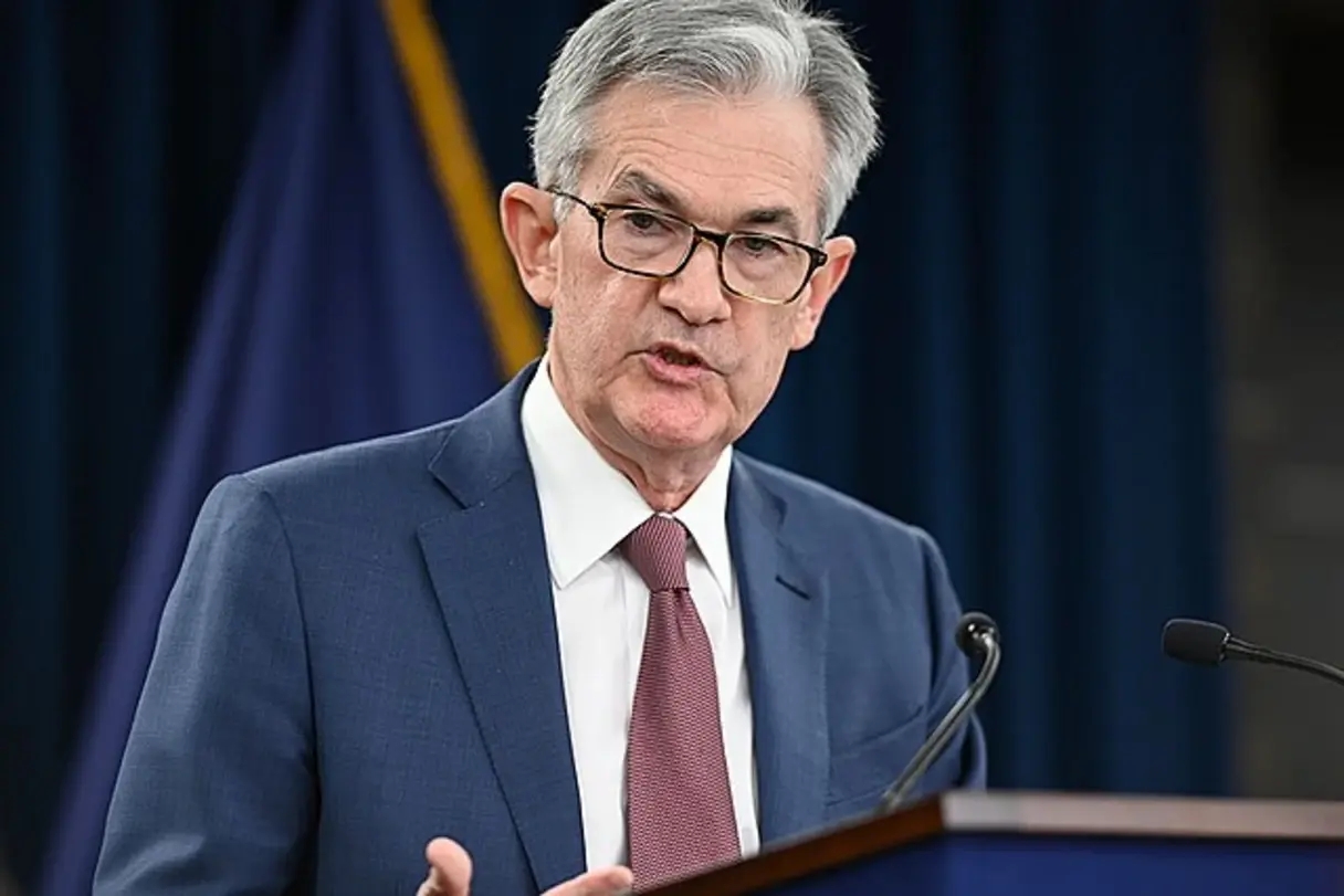 fed chair jerome powell addressing a meeting in a blue suit 