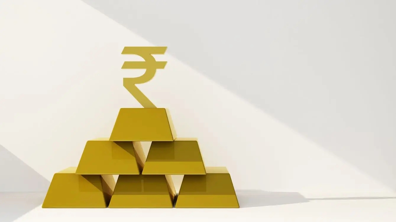 a pile of gold bars with a golden indian rupee symbol on top on a white background to represent India purchasing gold
