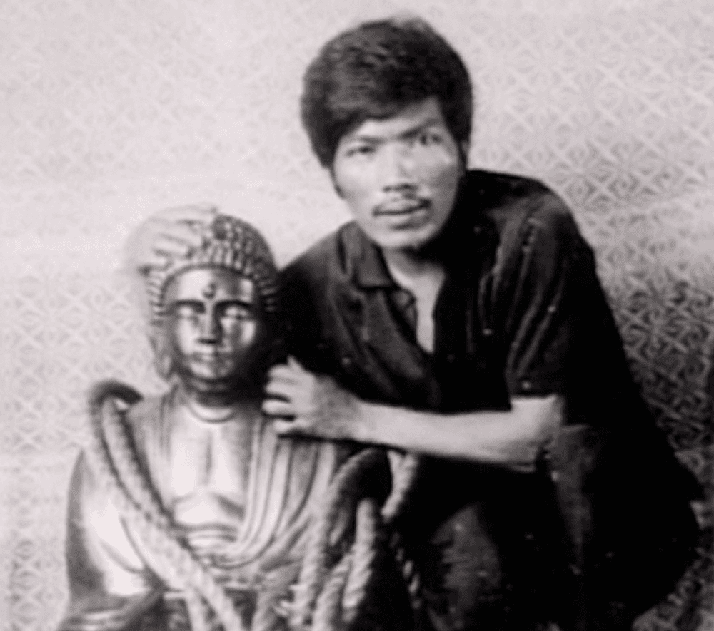 Yamashita's Gold: The Enduring WWII Treasure Mystery rogelio roxas the treasure hunter posing next to the golden buddha statue filled with diamonds that was part of the Yamashita treasure made of piles of gold bars and jewels looted during world war II