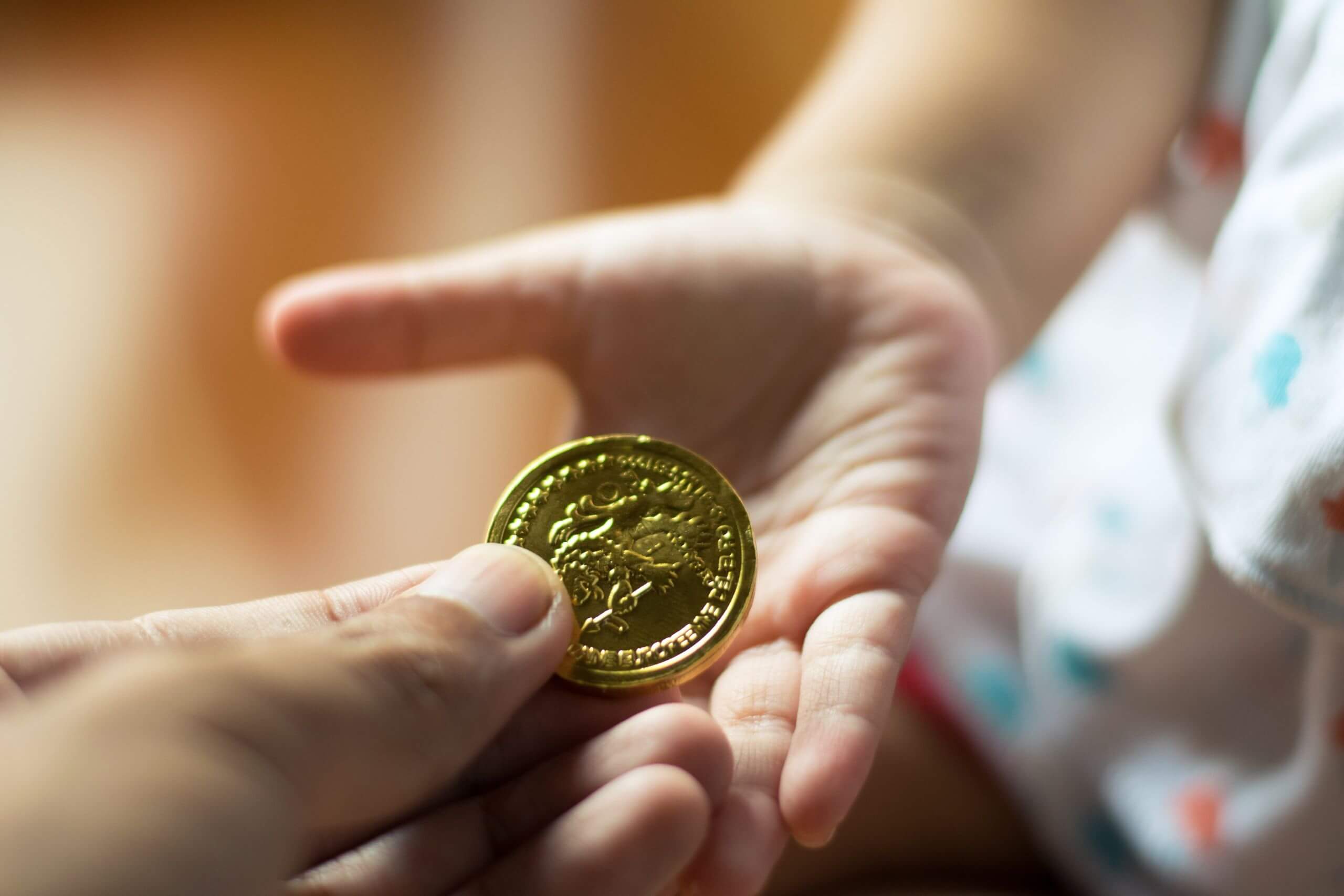A man gives his child a gold coin for Christmas A man gives his child a gold coin for Christmas