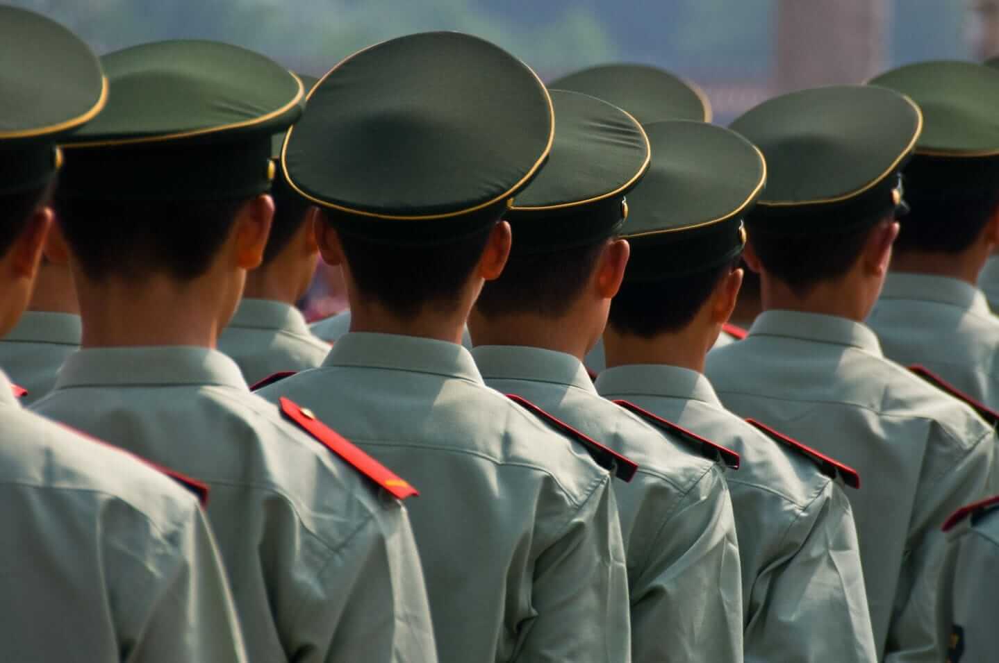 marching Chinese soldiers symbolizing rising tensions between China and the US marching Chinese soldiers symbolizing rising tensions between China and the US