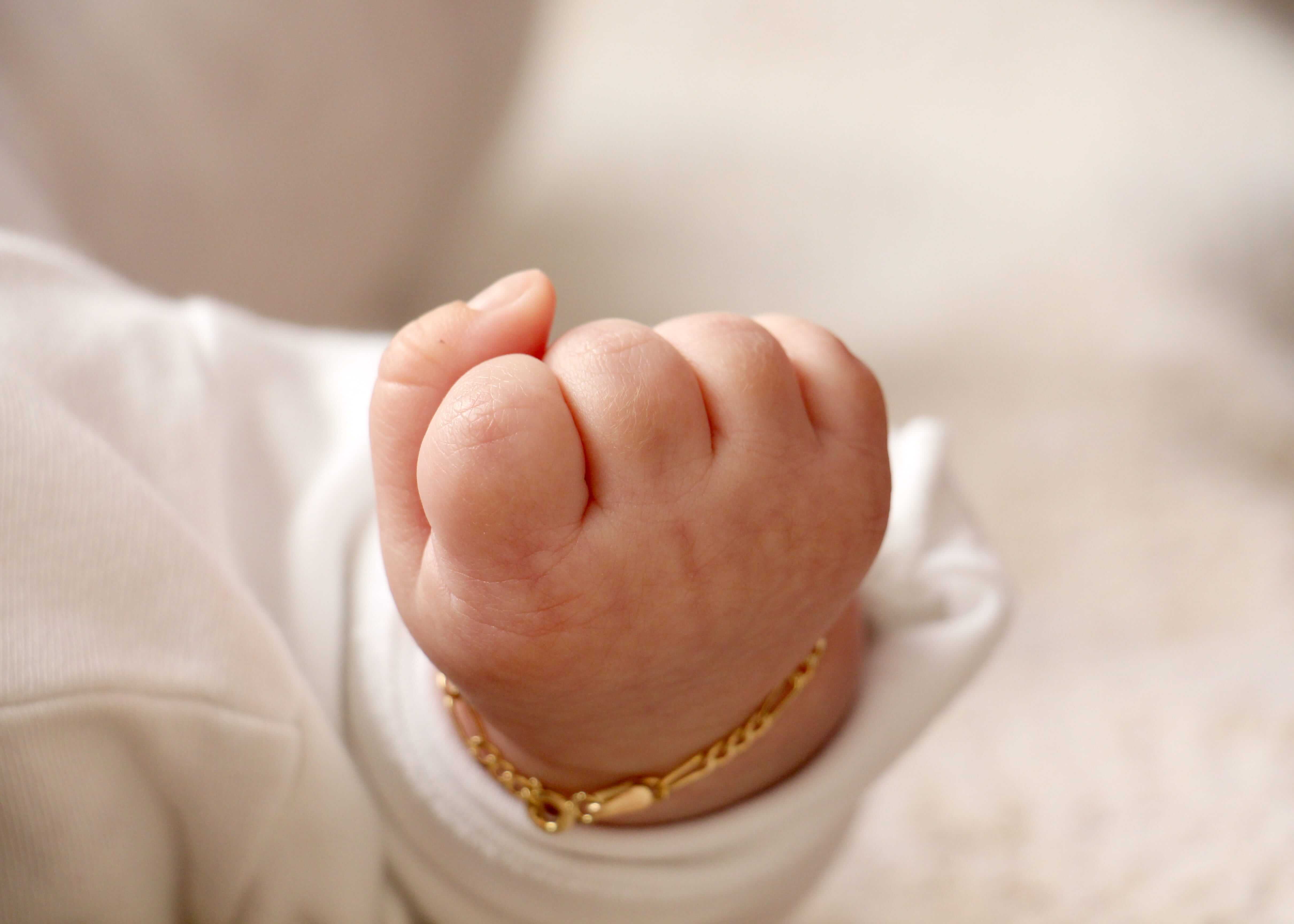 Baby fist with gold bracelet Baby fist with gold bracelet