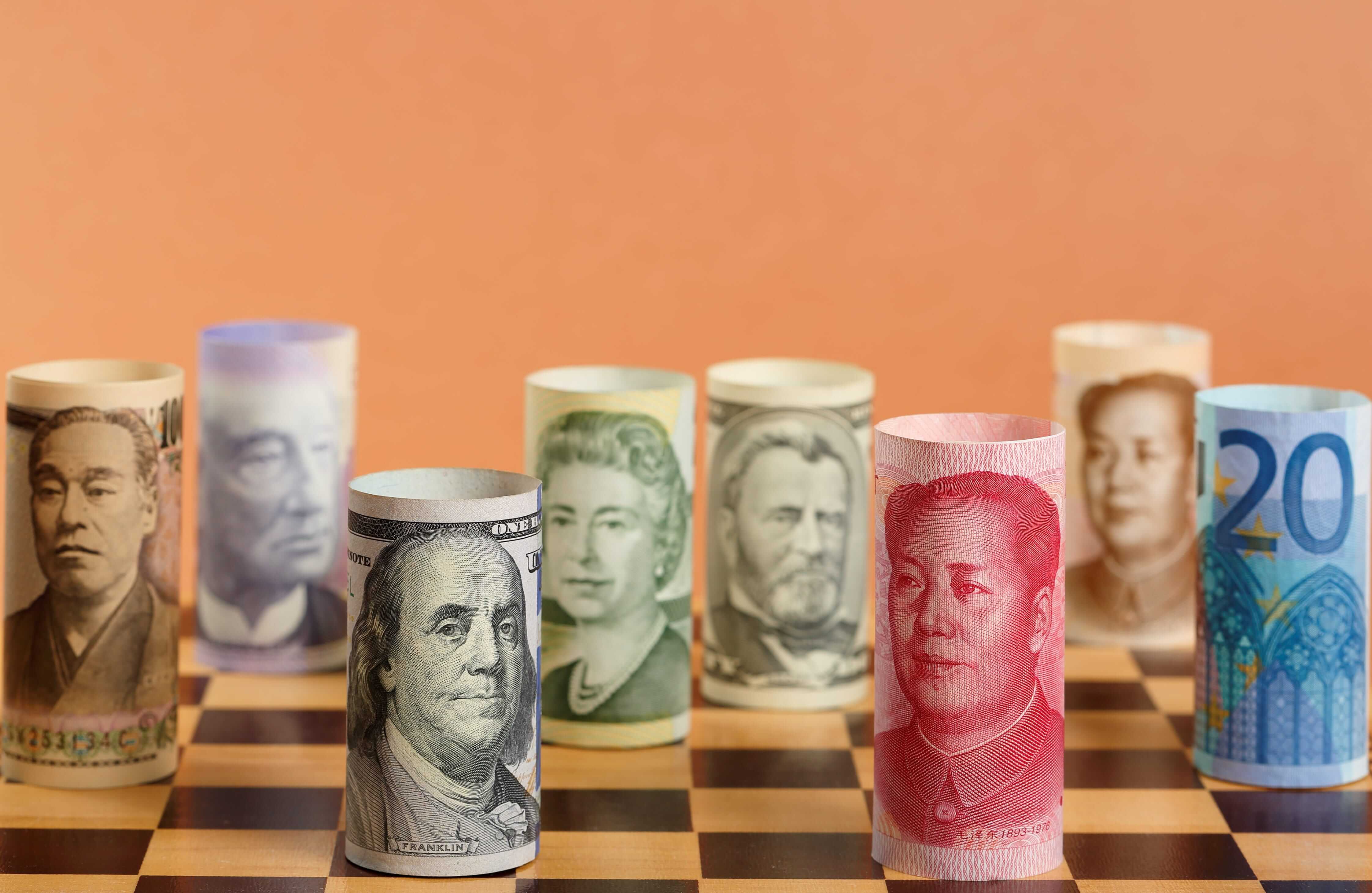 Chess wrapped in different banknotes on a chess board. Chess wrapped in different banknotes on a chess board.