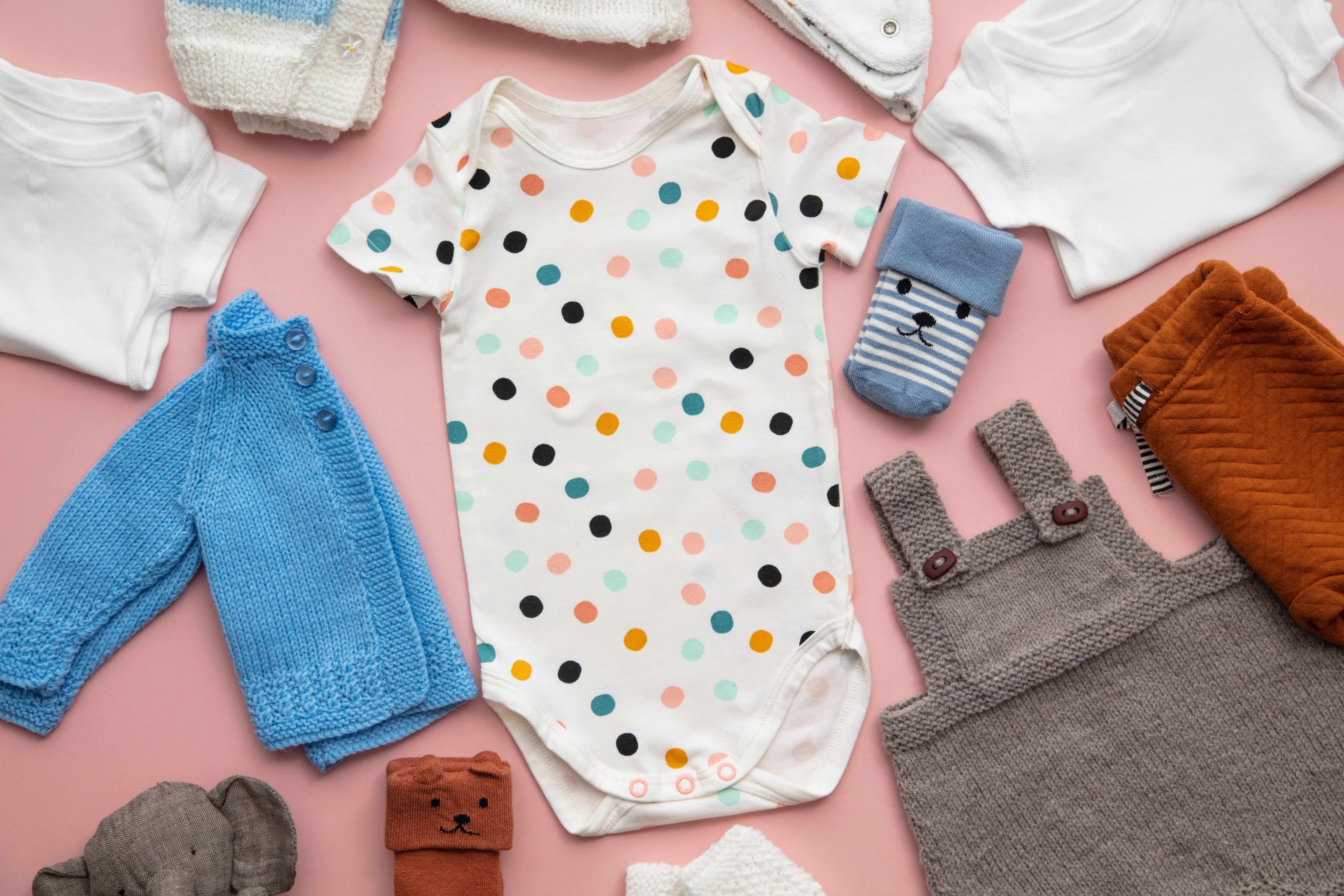 Baby clothes on a pink background Baby clothes on a pink background