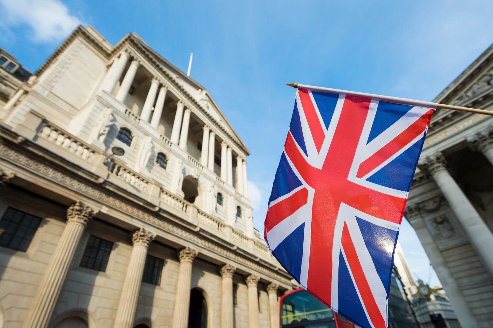 The Bank of England building and the British flag The Bank of England building and the British flag