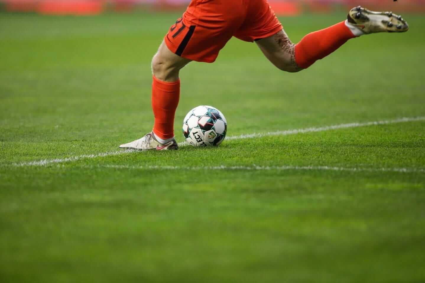 a football player in red socks kicking a ball during the 22nd FIFA World Cup in Qatar a football player in red socks kicking a ball during the 22nd FIFA World Cup in Qatar