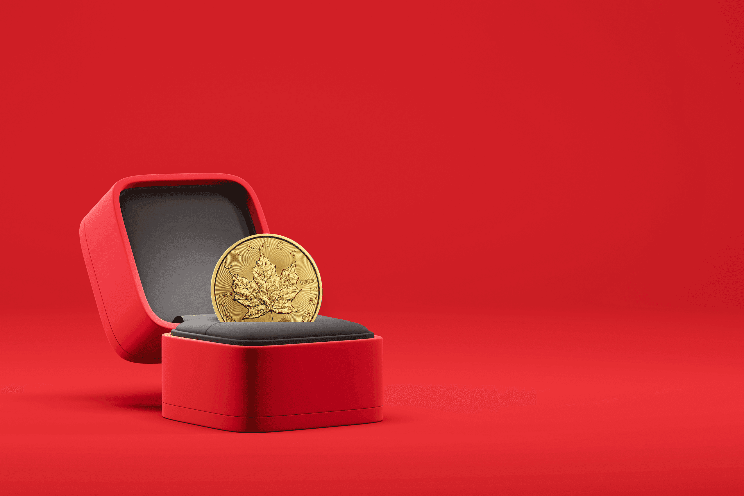 The Timeless Tradition of Gifting Gold Canadian Maple Leaf gold coin in a red ring box on a red background