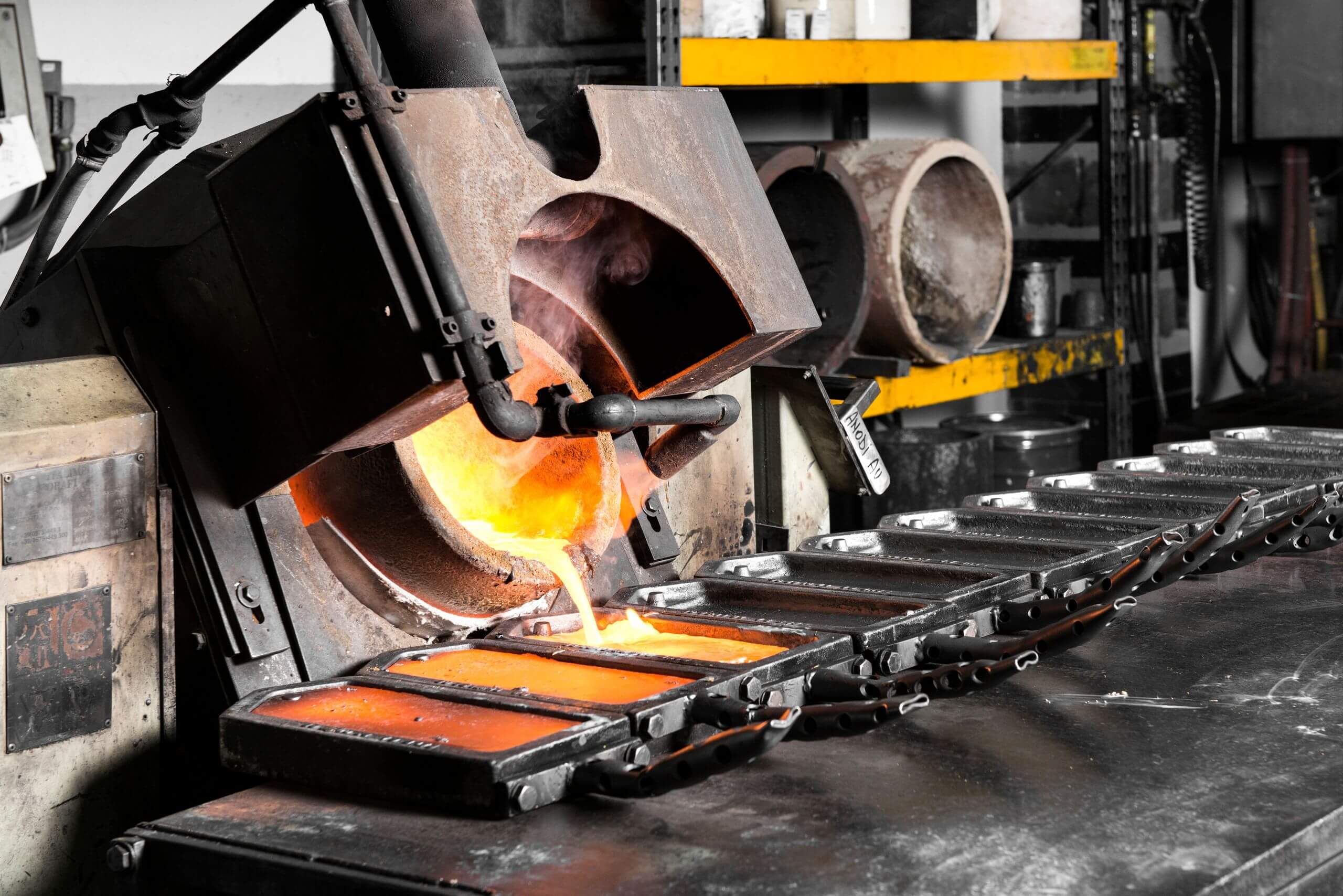 Gold melted into iron forms for refinement Gold melted into iron forms for refinement