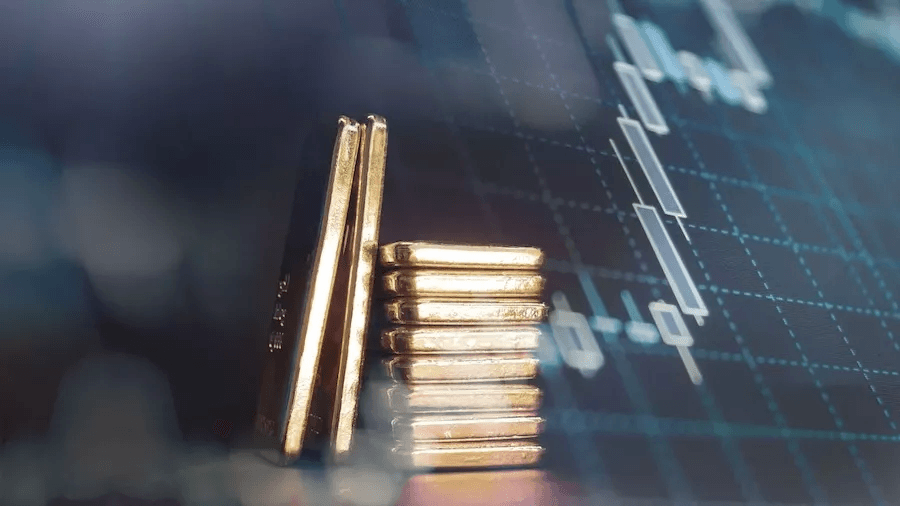 Lingots d'or devant des graphiques