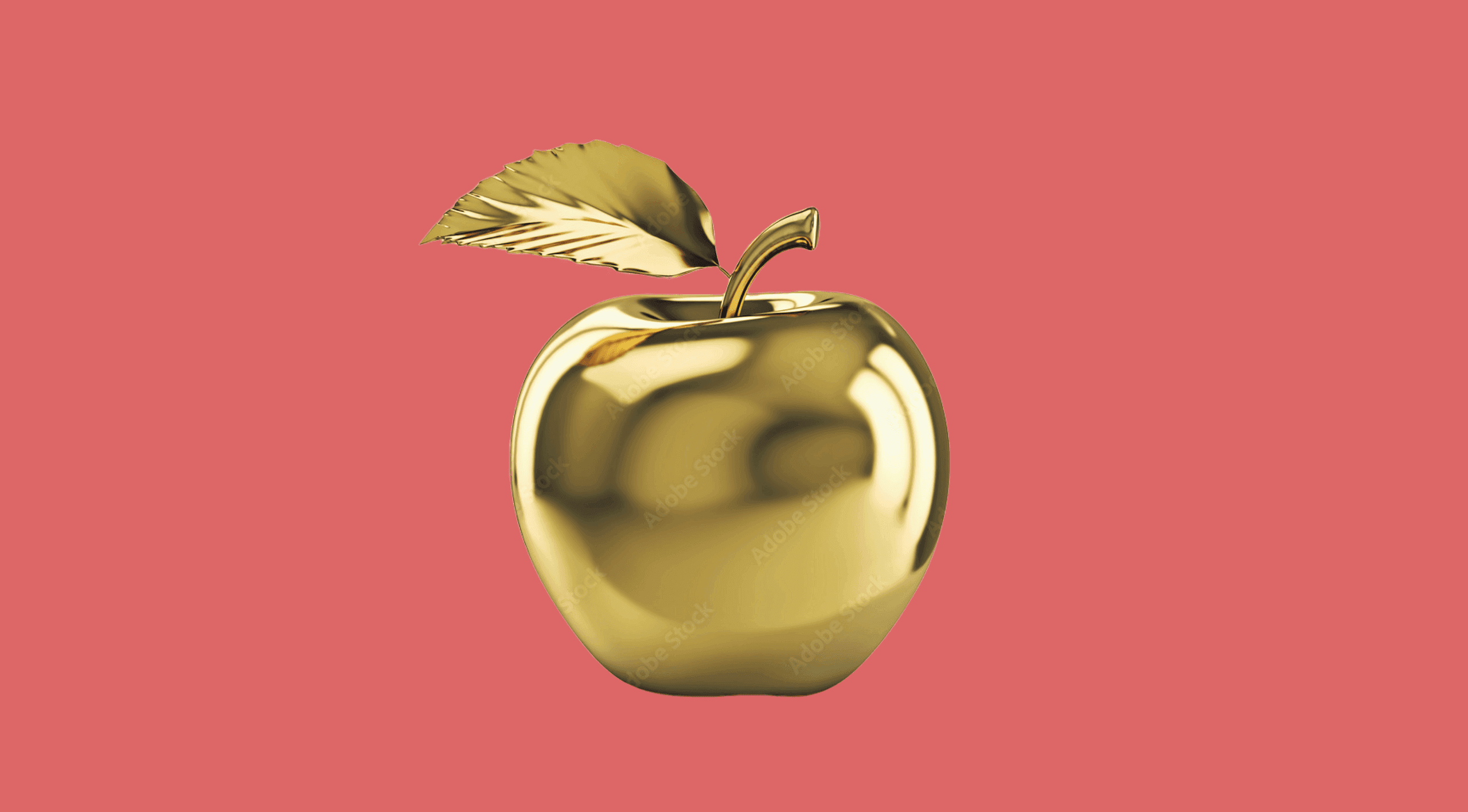 Une pomme en or sur fond rose Une pomme en or sur fond rose