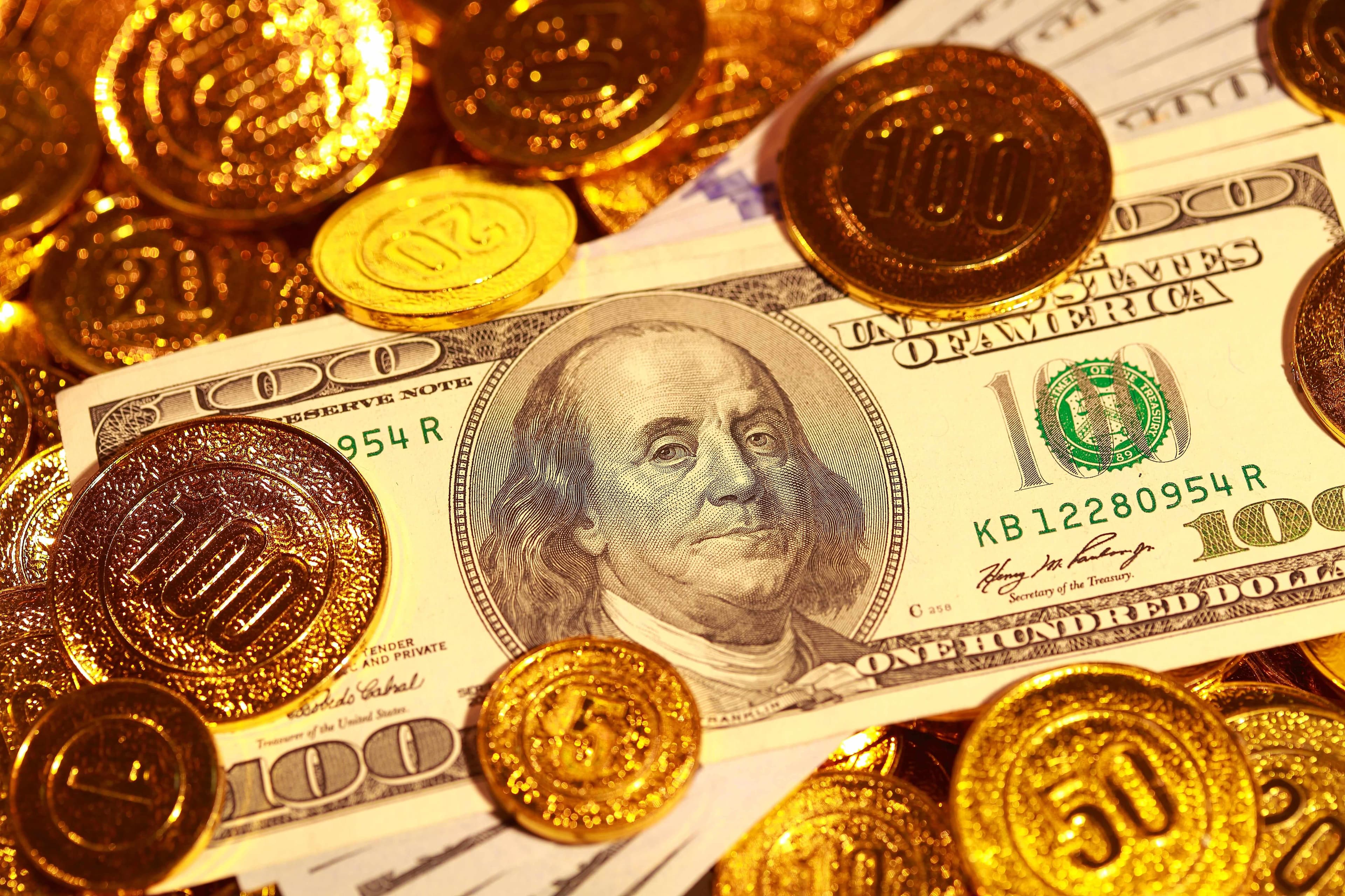 100 US dollars banknote and gold coins 100 US dollars banknote and gold coins