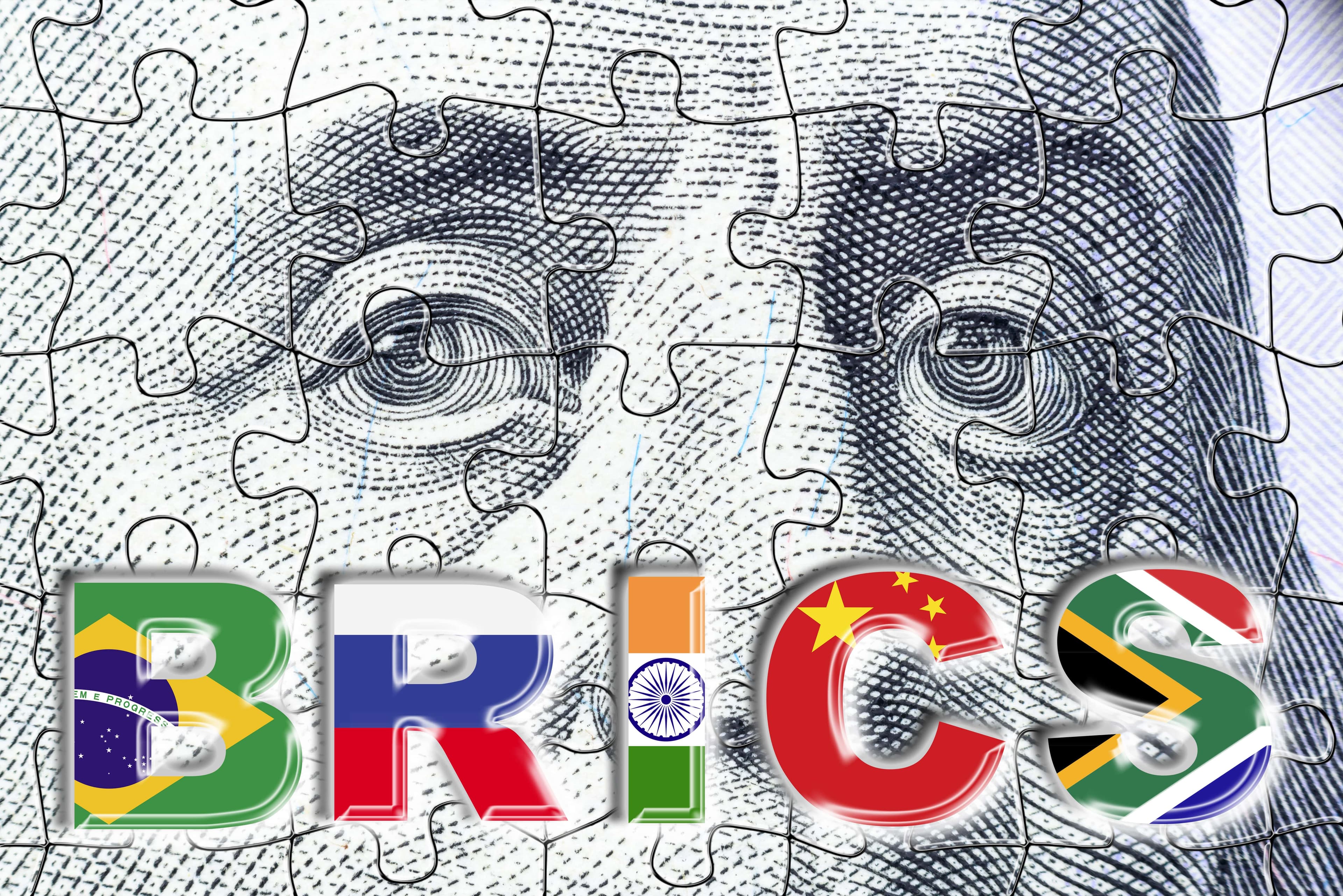 New BRICS Currency: What Impact on Gold and the Dollar? A puzzle composed of the U.S. dollar with letters "B", "R", "I", "C", "S".
