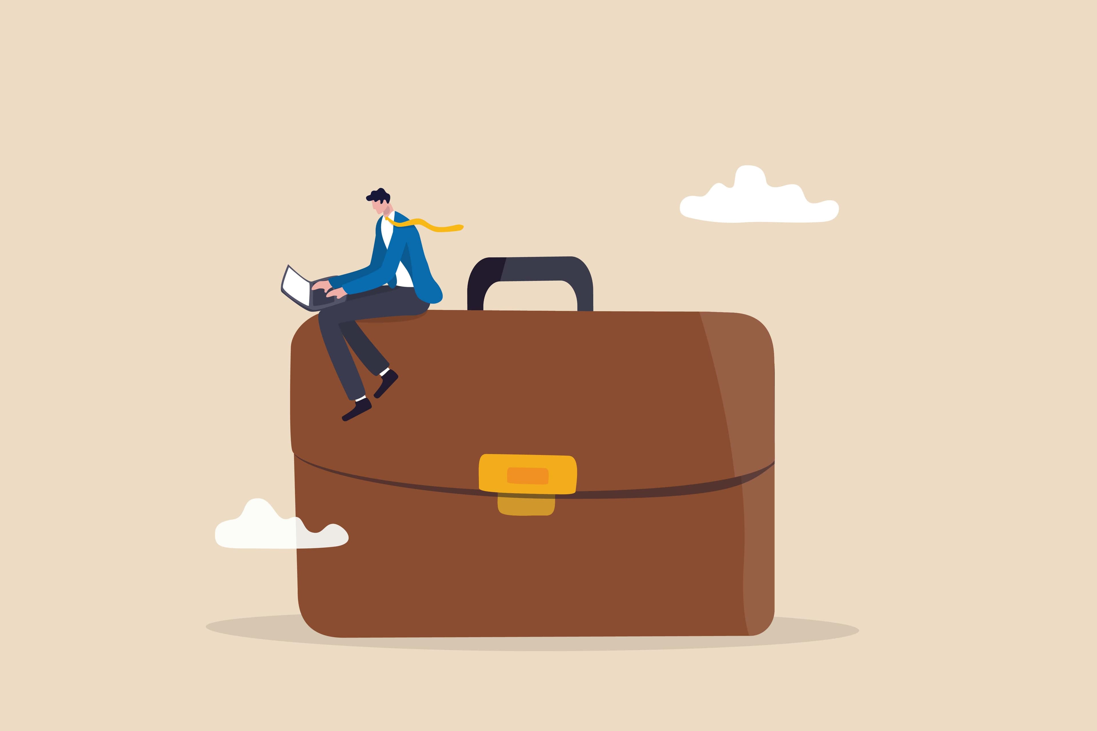 a man sitting on a briefcase a man sitting on a briefcase