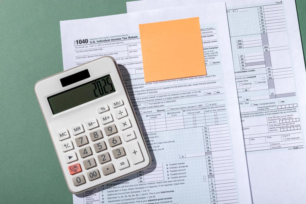 A calculator on top of taxes bills A calculator on top of taxes bills