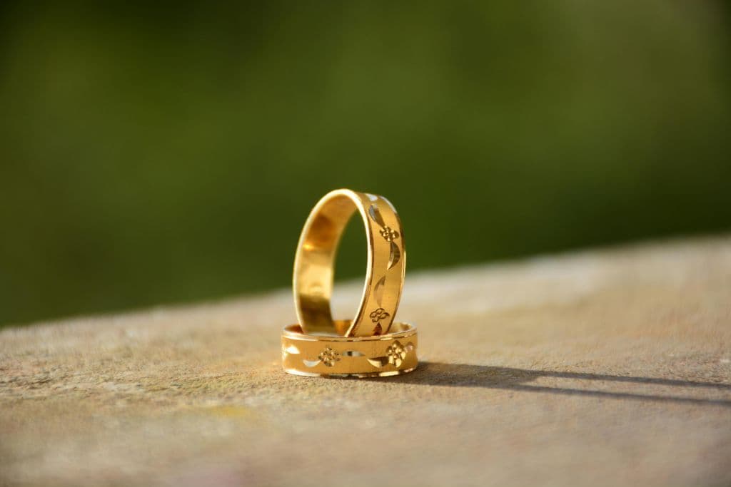bague en or avec des gravures, posée sur un autre bague en or bague en or avec des gravures, posée sur un autre bague en or